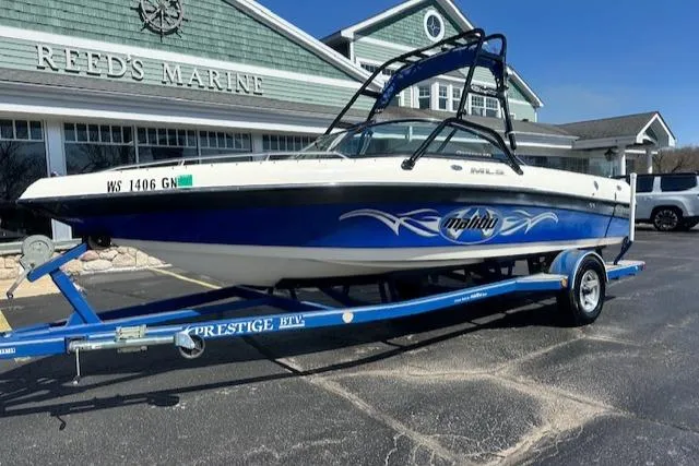 Slide: The Image of 2003 Malibu Wakesetter VLX boat on trailer outside Reeds Marine. - 0