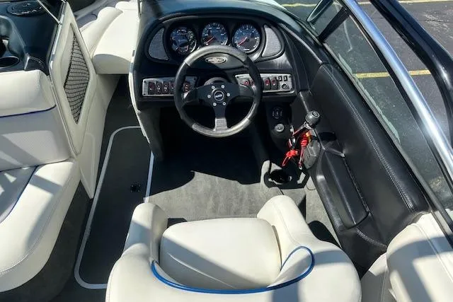 Slide: The Image of 2003 Malibu Wakesetter VLX boat interior with steering wheel and dashboard controls. - 11