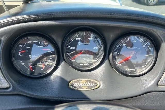 Slide: The Image of Dashboard gauges of a 2003 Malibu Wakesetter VLX boat. - 13