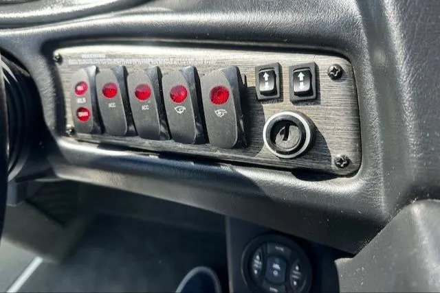 Slide: The Image of Control panel of a 2003 Malibu Wakesetter VLX boat with switches and ignition. - 16