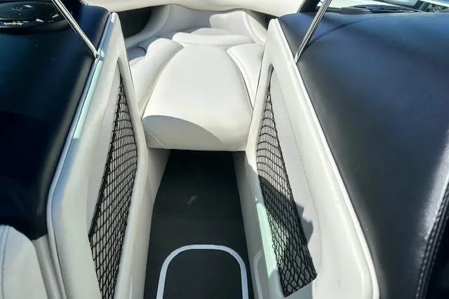 Slide: The Image of 2003 Malibu Wakesetter VLX interior with white and black seating, mesh storage pockets. - 18