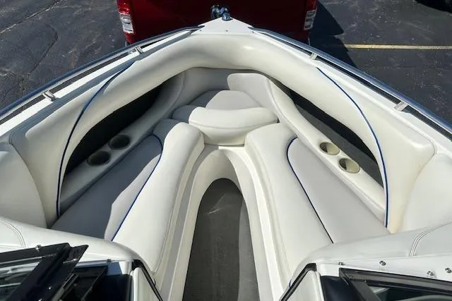 Slide: The Image of 2003 Malibu Wakesetter VLX boat interior with white cushioned seating and cup holders. - 20