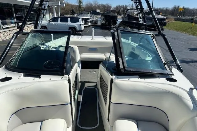 Slide: The Image of 2003 Malibu Wakesetter VLX boat interior with white seating and open windshield. - 21