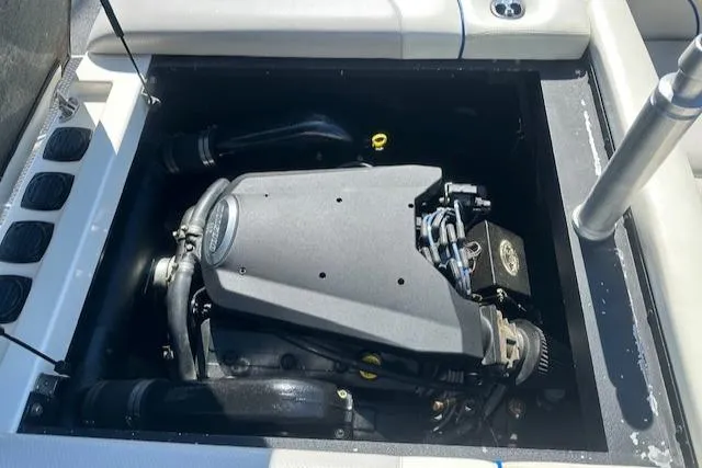 Slide: The Image of Engine compartment of a 2003 Malibu Wakesetter VLX boat, showcasing the engine details. - 27