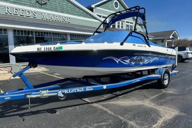 Slide: The Image of 2003 Malibu Wakesetter VLX boat on trailer outside Reeds Marine. - 28