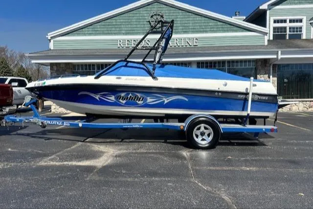 Slide: The Image of 2003 Malibu Wakesetter VLX boat on trailer in front of marine store. - 29