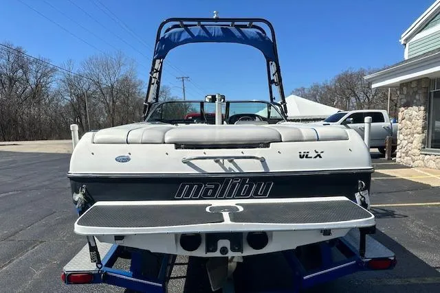 Slide: The Image of 2003 Malibu Wakesetter VLX boat with blue tower, parked outdoors. - 3
