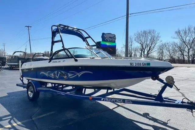 Slide: The Image of 2003 Malibu Wakesetter VLX boat on trailer in parking lot, sunny day. - 4