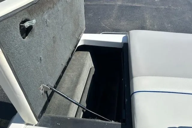Slide: The Image of 2003 Malibu Wakesetter VLX open storage compartment with cushioned seating. - 8