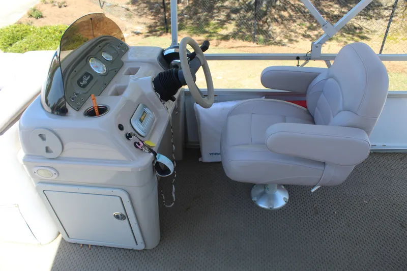 Slide: The Image of 2013 SunChaser 8520 Cruise boat helm with steering wheel and captain's chair. - 10