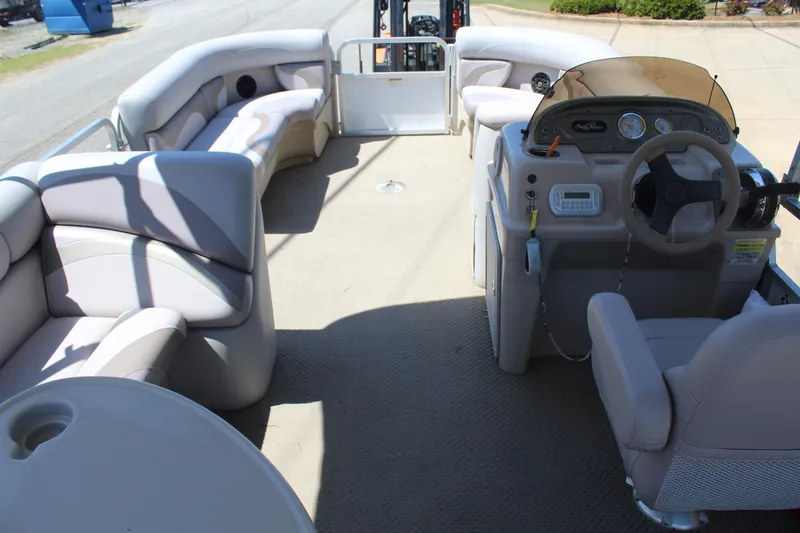 Slide: The Image of 2013 SunChaser 8520 Cruise pontoon boat interior with plush seating and steering console. - 11