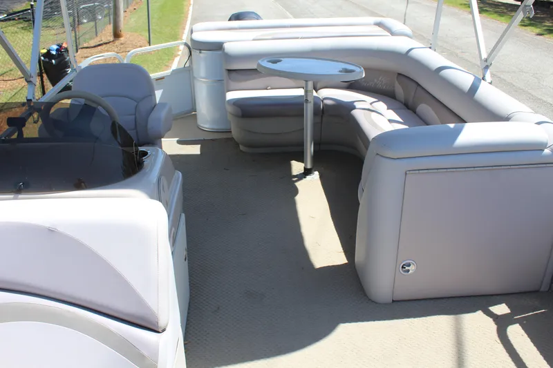 Slide: The Image of 2013 SunChaser 8520 Cruise pontoon boat interior with plush seating and table. - 12