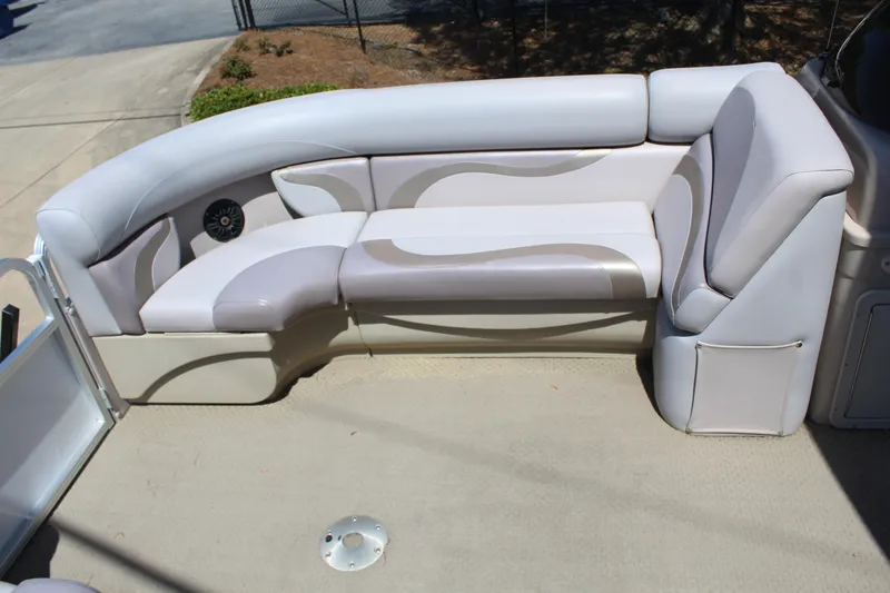 Slide: The Image of 2013 SunChaser 8520 Cruise boat interior with cushioned seating and speaker. - 17
