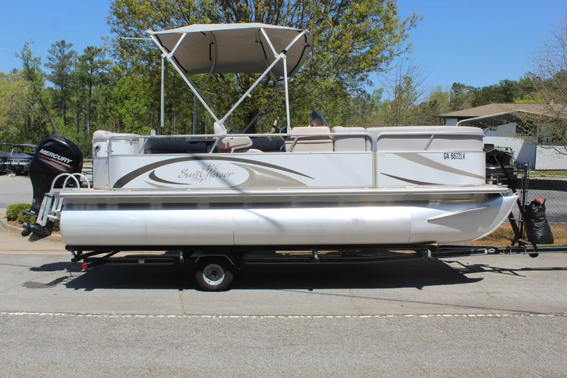 Slide: The Image of 2013 SunChaser 8520 Cruise pontoon boat on trailer, parked outdoors. - 6