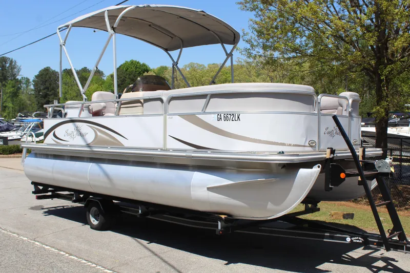 Slide: The Image of 2013 SunChaser 8520 Cruise pontoon boat on trailer, parked outdoors. - 8