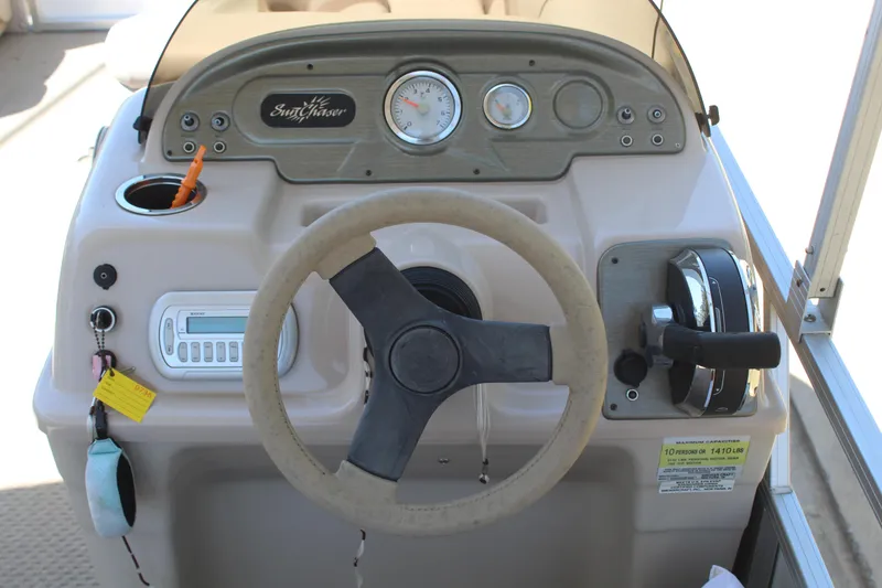 Slide: The Image of 2013 SunChaser 8520 Cruise boat dashboard with steering wheel and control panel. - 9