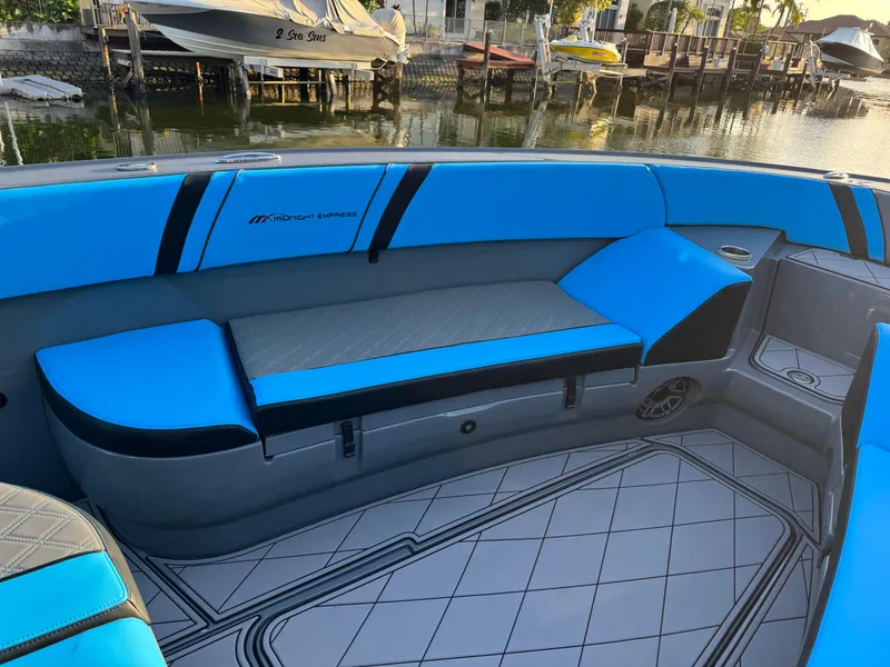 Slide: The Image of 2021 Midnight Express 37 Open boat interior with blue seating by the water. - 11