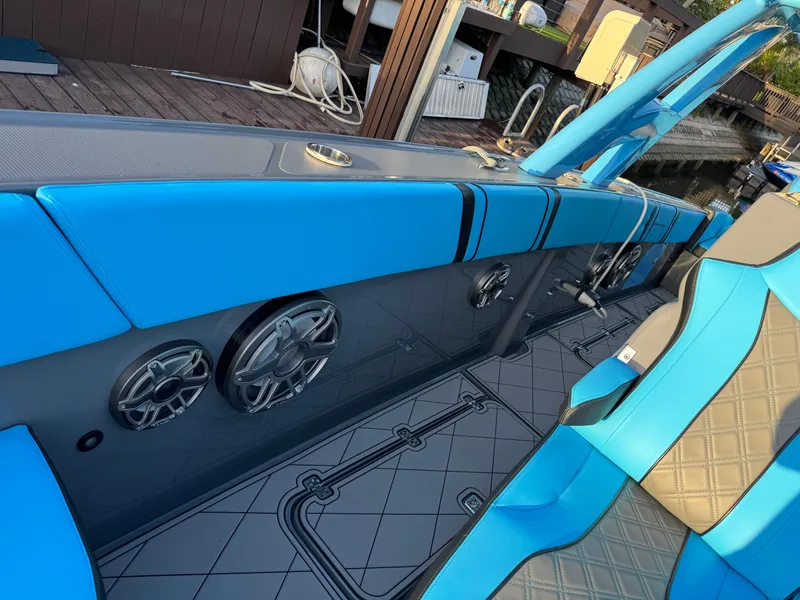Slide: The Image of 2021 Midnight Express 37 Open boat interior with blue seating and built-in speakers. - 12