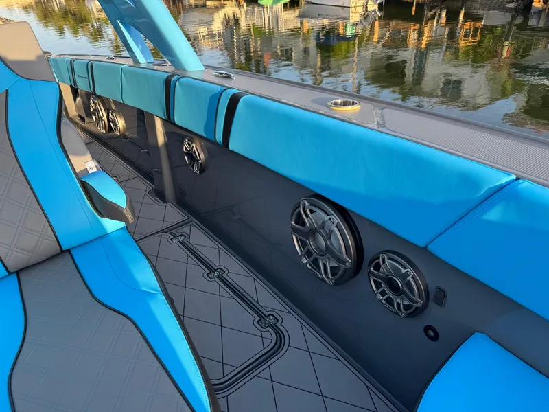 Slide: The Image of 2021 Midnight Express 37 Open boat interior with blue seating and built-in speakers. - 13