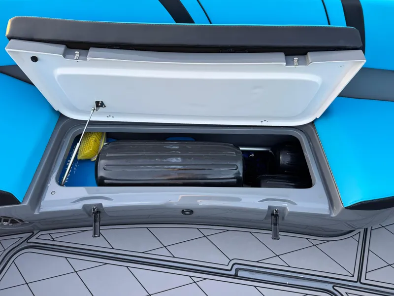 Slide: The Image of Open storage compartment on 2021 Midnight Express 37 Open boat, featuring blue seating and deck. - 19