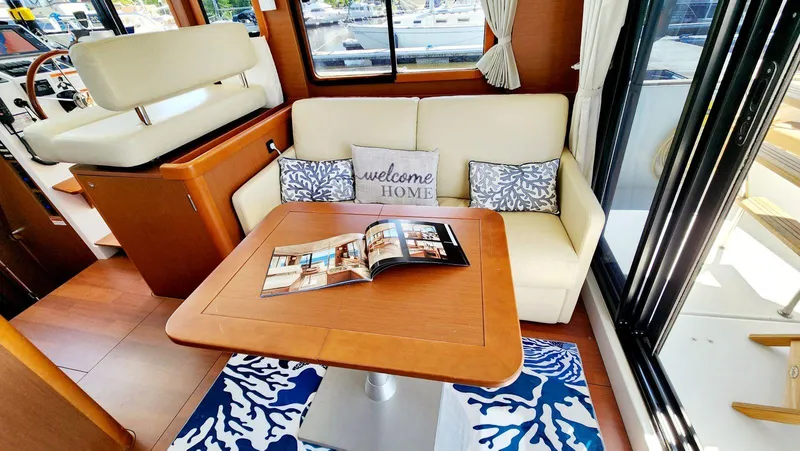 Slide: The Image of Interior of 2015 Beneteau Swift Trawler 34 with cozy seating and nautical decor. - 15
