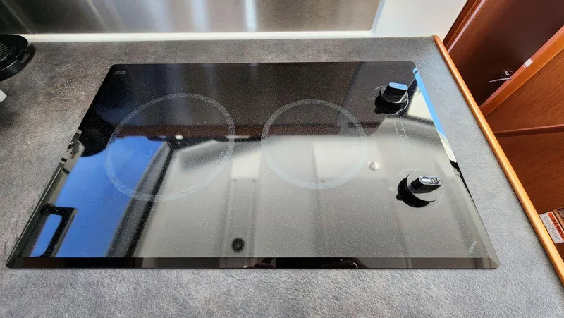 Slide: The Image of Glass cooktop in a 2015 Beneteau Swift Trawler 34 kitchen area. - 25