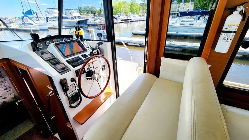 Slide: The Image of Helm of 2015 Beneteau Swift Trawler 34 with navigation equipment and comfortable seating. - 29