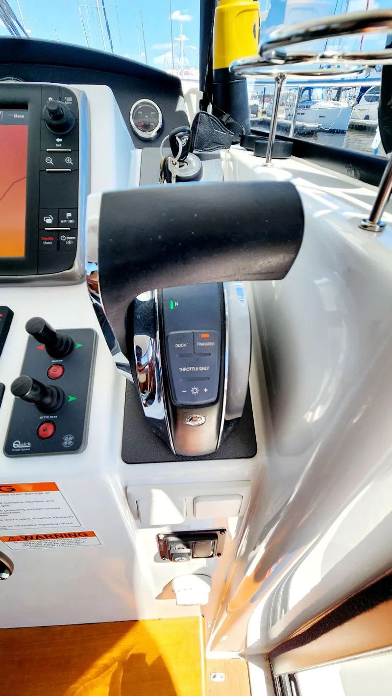 Slide: The Image of Control panel of a 2015 Beneteau Swift Trawler 34, featuring throttle and navigation controls. - 34