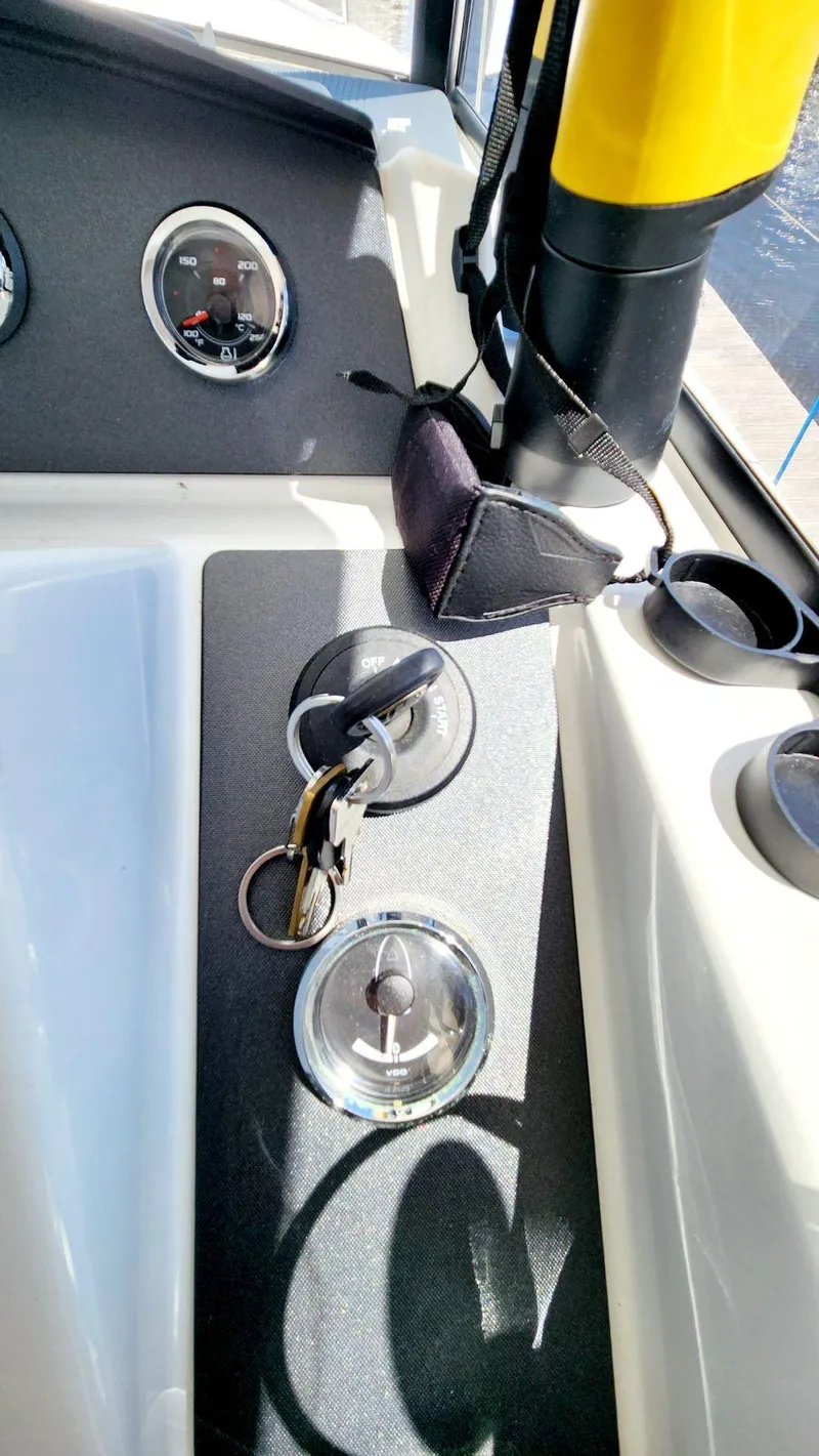 Slide: The Image of Dashboard of a 2015 Beneteau Swift Trawler 34 with keys and gauges. - 35