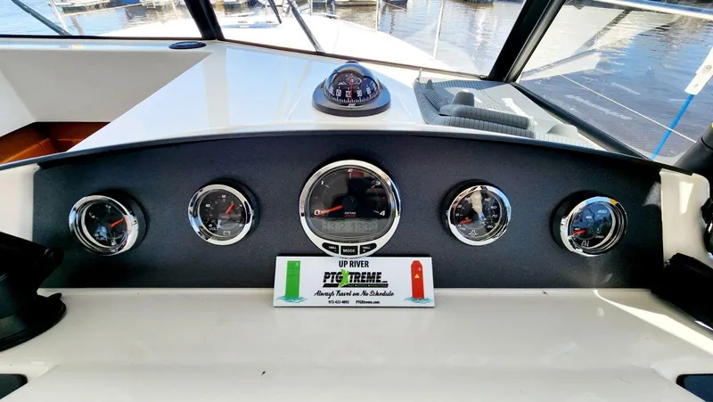 Slide: The Image of Dashboard of a 2015 Beneteau Swift Trawler 34 with gauges and compass. - 36