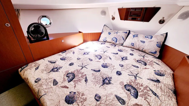 Slide: The Image of Cozy cabin interior of 2015 Beneteau Swift Trawler 34 with nautical-themed bedding. - 39