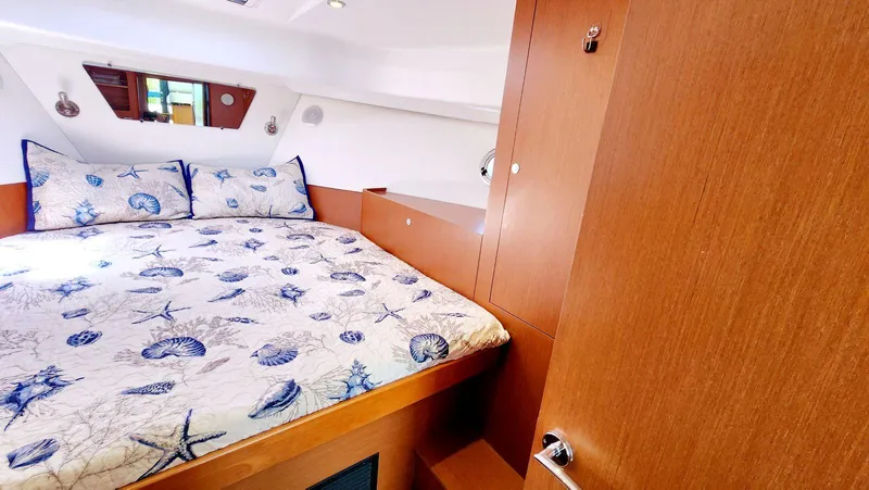 Slide: The Image of Cozy cabin interior of 2015 Beneteau Swift Trawler 34 with nautical-themed bedding. - 40