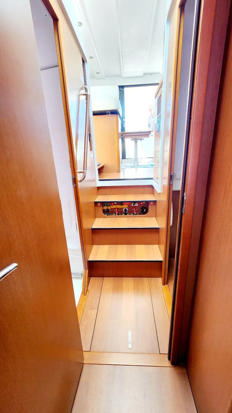 Slide: The Image of Interior view of 2015 Beneteau Swift Trawler 34, featuring wooden stairs and modern design. - 45