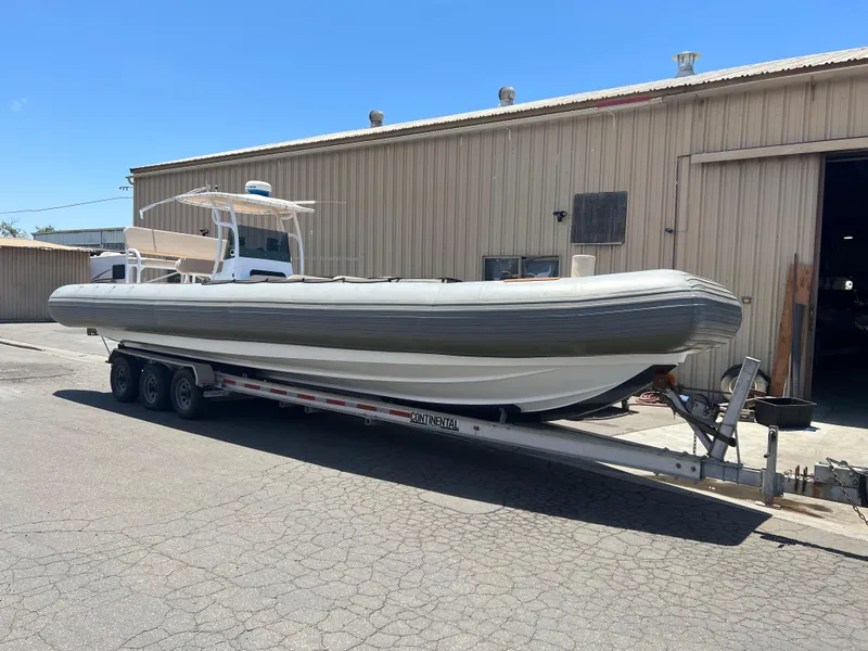 Slide: The Image of 1995 Nautica 33 Commercial RIB on trailer, parked outside industrial building. - 10