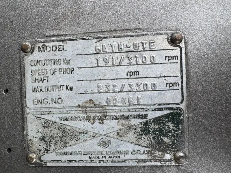 Slide: The Image of Metallic engine specification plate with model details and performance metrics. - 13