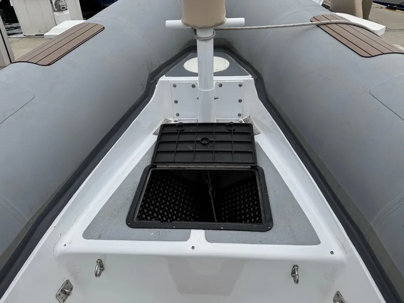 Slide: The Image of 1995 Nautica 33 Commercial RIB with open storage compartment on deck. - 7