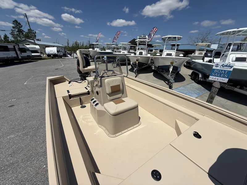 Slide: The Image of 2025 G3 Bay 20 boat displayed at a dealership under a clear blue sky. - 11