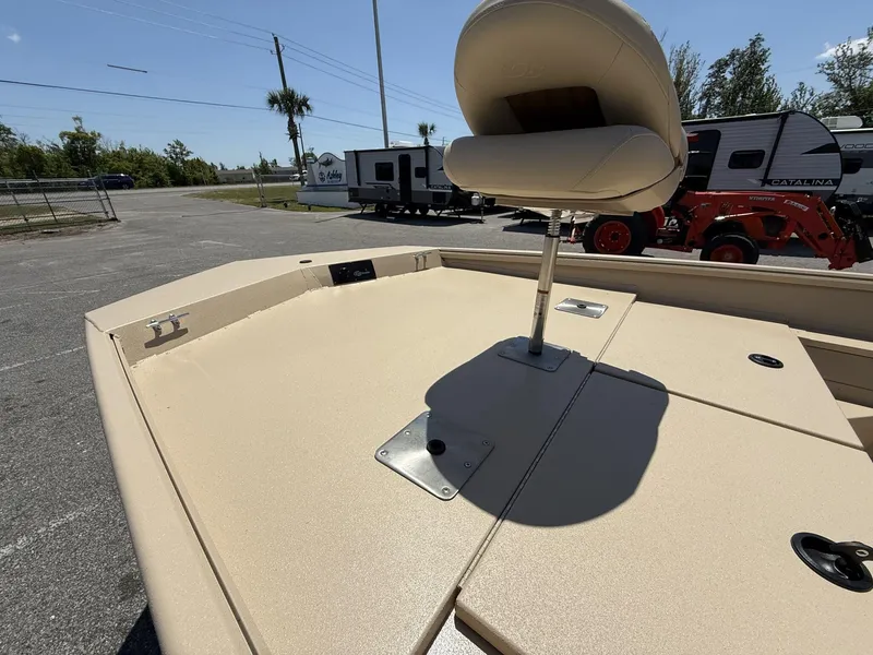 Slide: The Image of 2025 G3 Bay 20 boat deck with seat, parked near RVs and tractor. - 9