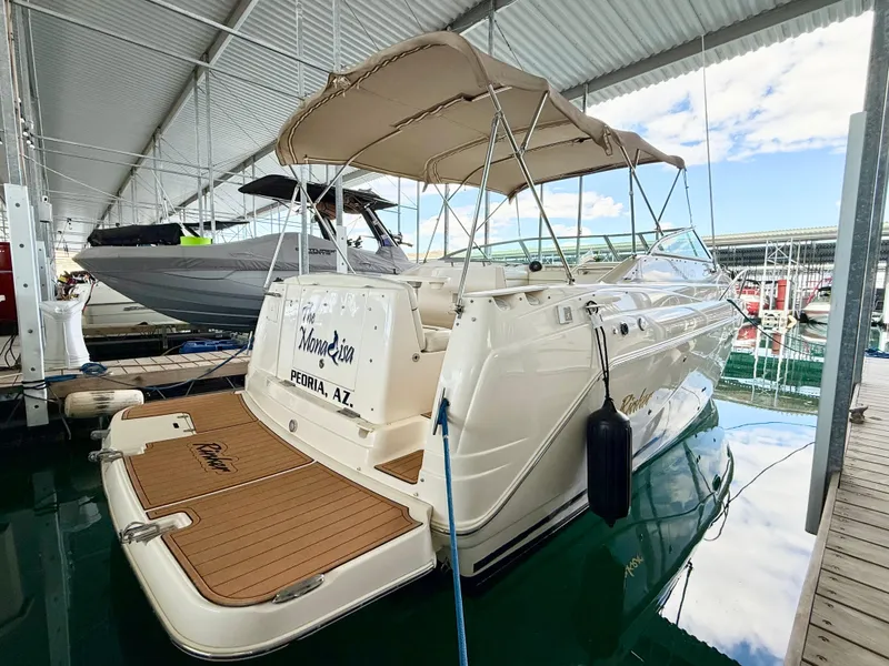 Slide: The Image of 2006 Rinker 270 Express Cruiser docked under a covered marina. - 1