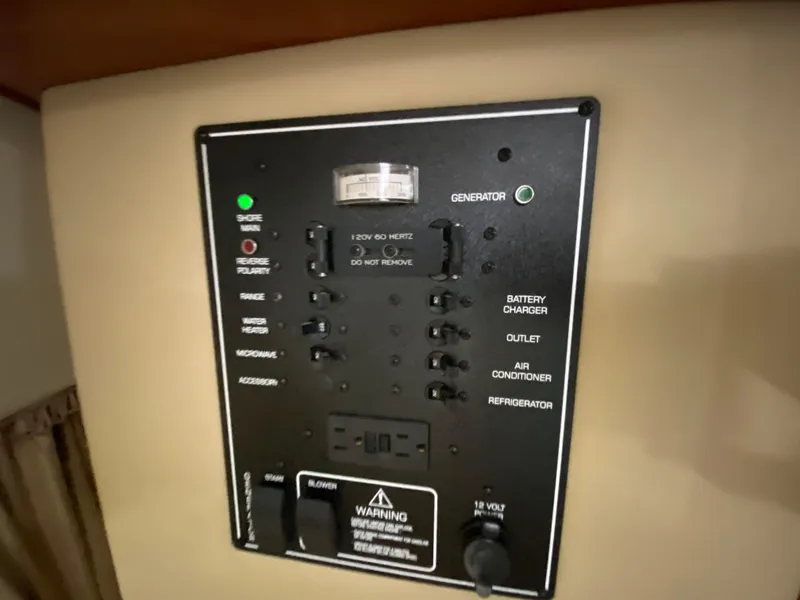 Slide: The Image of Control panel of a 2006 Rinker 270 Express Cruiser boat with various switches and indicators. - 18