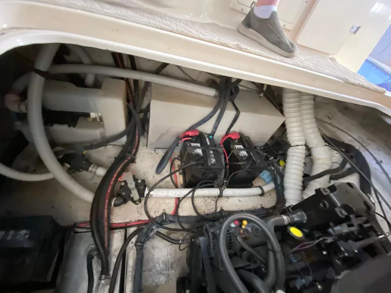 Slide: The Image of Engine compartment of a 2006 Rinker 270 Express Cruiser with visible wiring and components. - 24