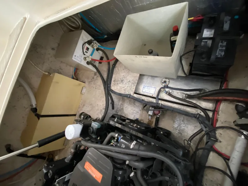 Slide: The Image of Engine compartment of a 2006 Rinker 270 Express Cruiser with visible wiring and components. - 26