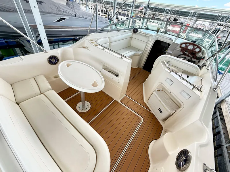 Slide: The Image of 2006 Rinker 270 Express Cruiser interior with seating, table, and helm. - 7