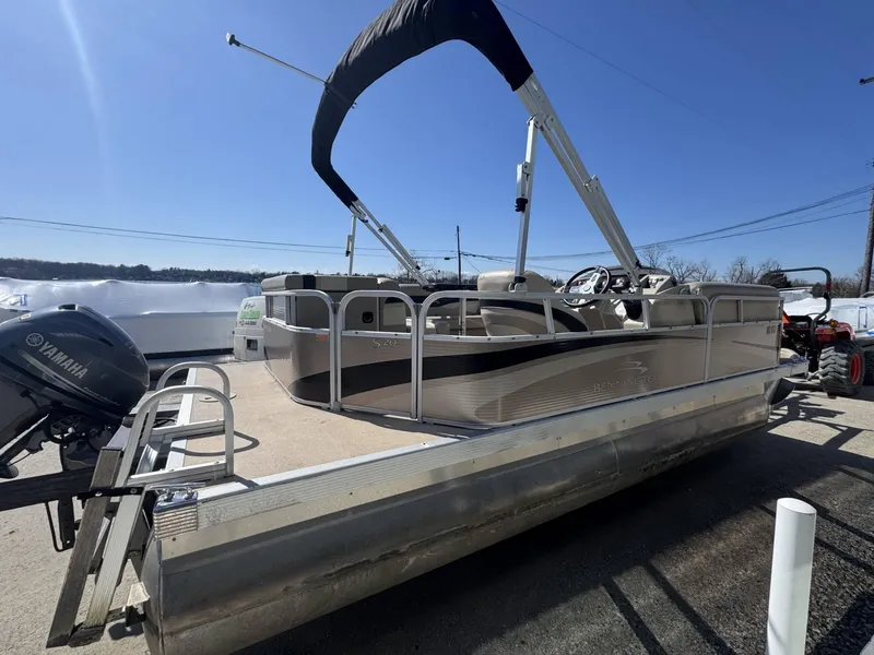 Slide: The Image of 2015 Bennington 20 SL pontoon boat with Yamaha motor, parked outdoors. - 3