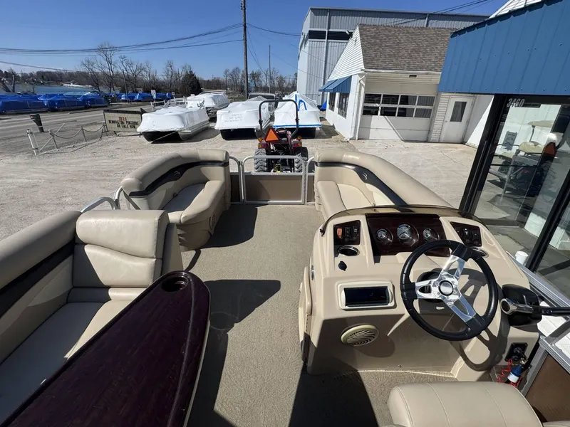 Slide: The Image of 2015 Bennington 20 SL pontoon boat interior with beige seating and steering console. - 6
