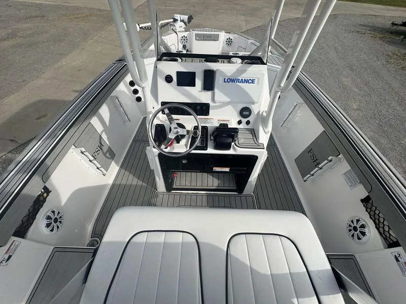 Slide: The Image of 2023 Yamaha Boats 220 FSH Sport interior with steering console and Lowrance electronics. - 4