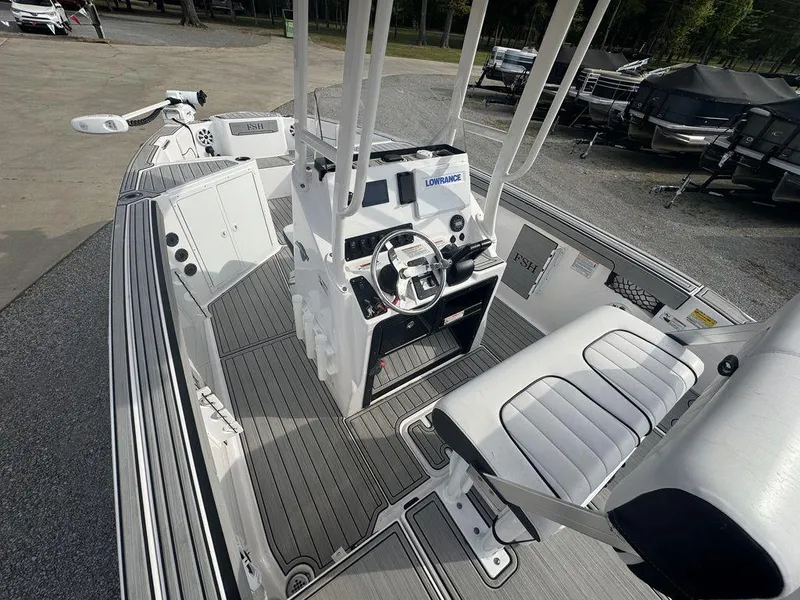 Slide: The Image of 2023 Yamaha Boats 220 FSH Sport interior with steering console and seating. - 5