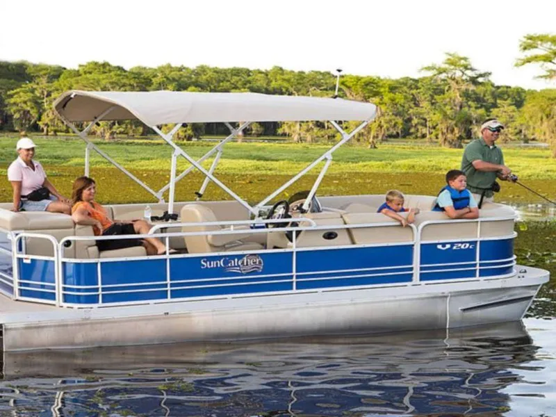 Slide: The Image of 2014 SunCatcher V20 C pontoon boat with passengers enjoying a scenic lake outing. - 0
