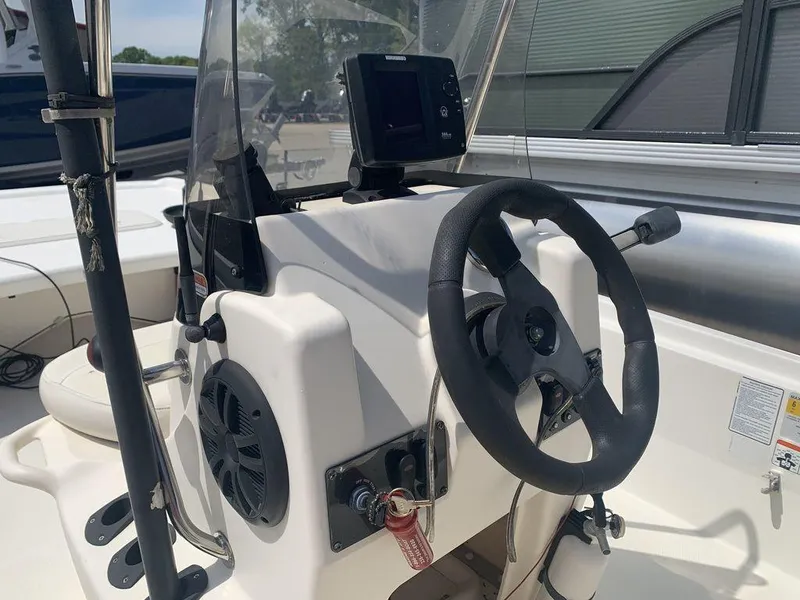 Slide: The Image of Steering console of a 2012 Mako PRO 17 SKIFF boat with navigation equipment. - 2