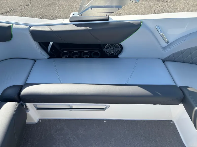 Slide: The Image of 2015 MasterCraft X23 boat interior with cushioned seating and speaker system. - 10